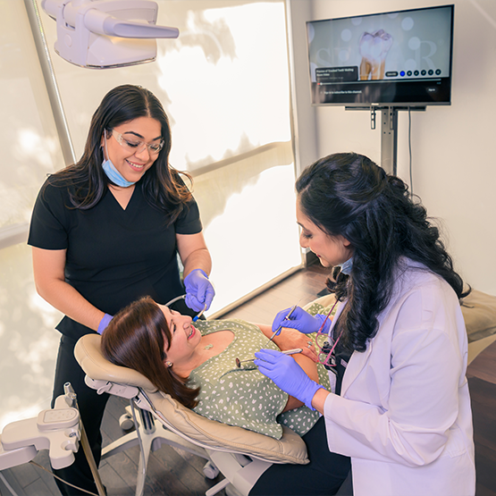 Fremont dentist and team member treating patient