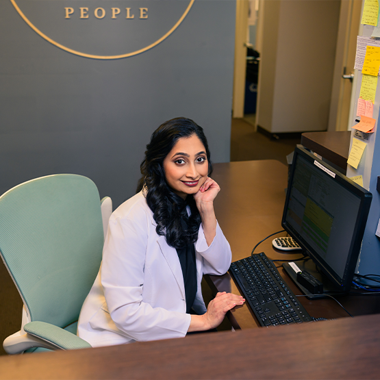 Dental team member sitting at front desk in dental office