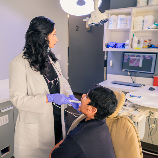 Examining patient's teeth with intraoral camera