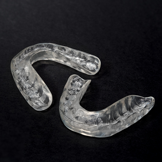 Two nightguards on a black surface
