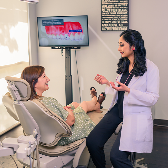 Dentist talking to patient in dental chair