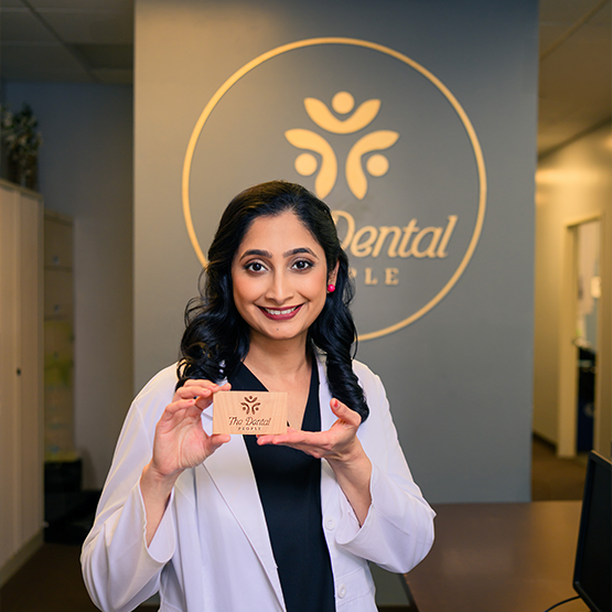 Dr. Gaddam holding up her business cards