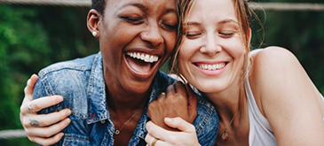 Two women smiling and hugging