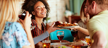 People gathered around table enjoying meal