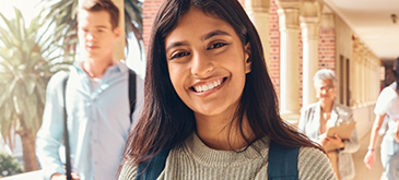 Young woman walking outside and smiling